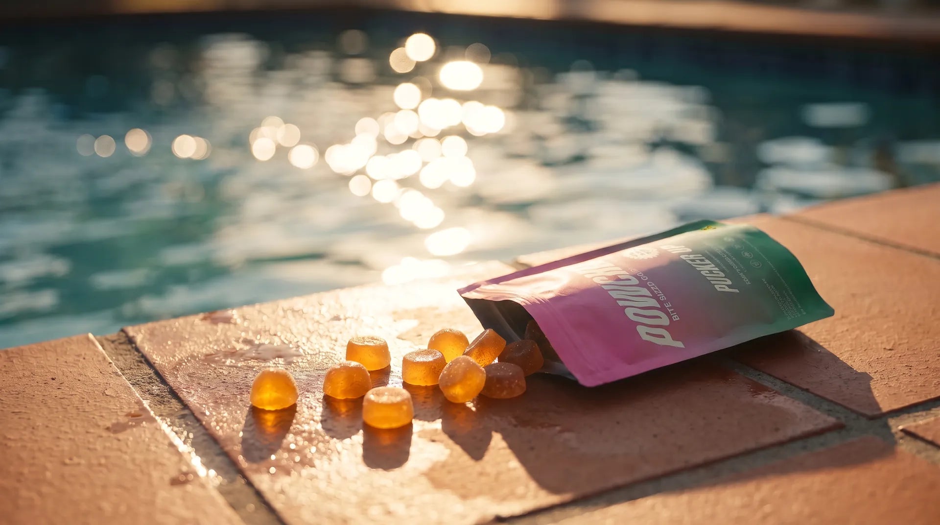 Pucker Up gummies tipped out of the pouch on a sunlit pool deck